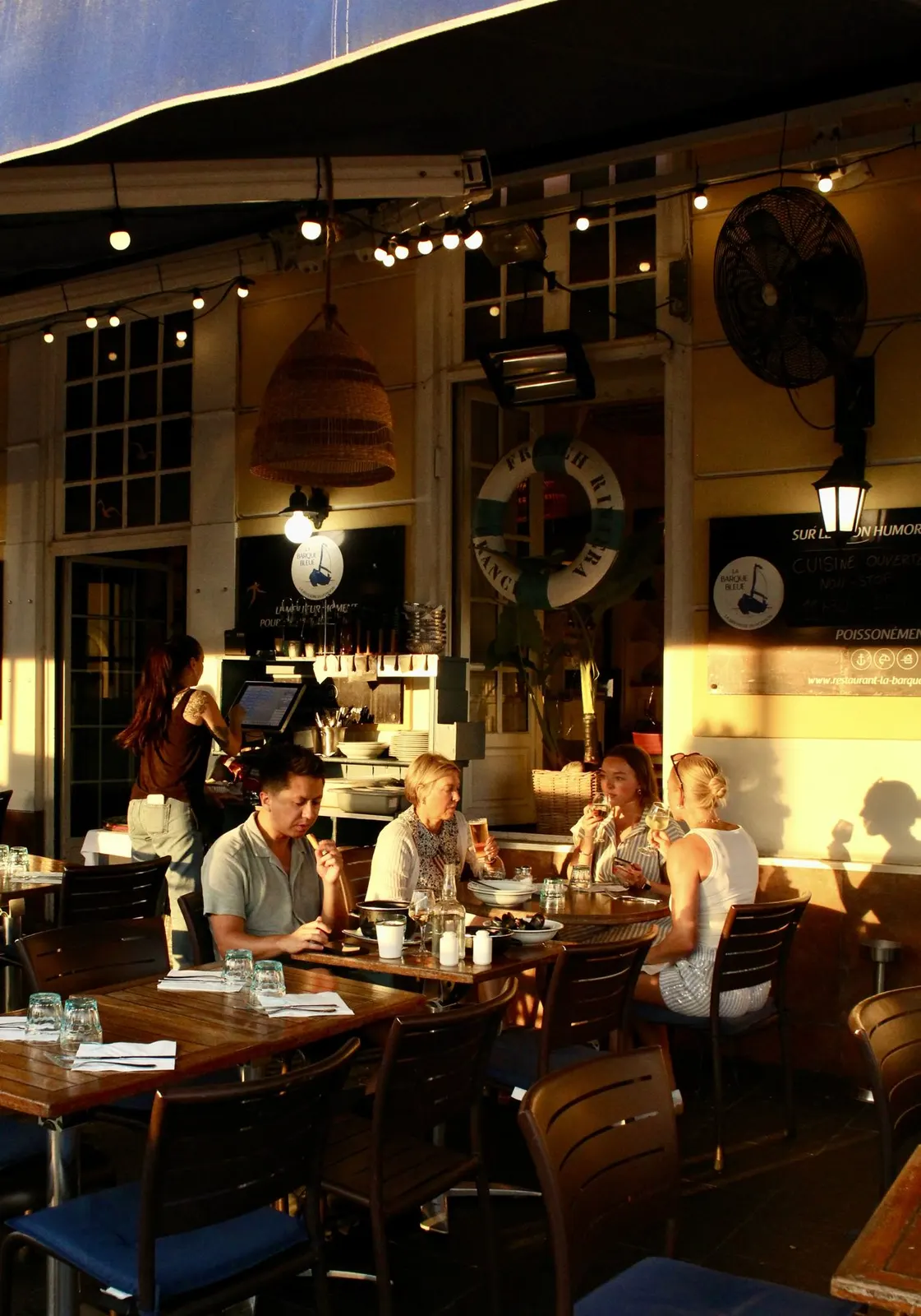 The dining room of La Barque Bleue in the evening